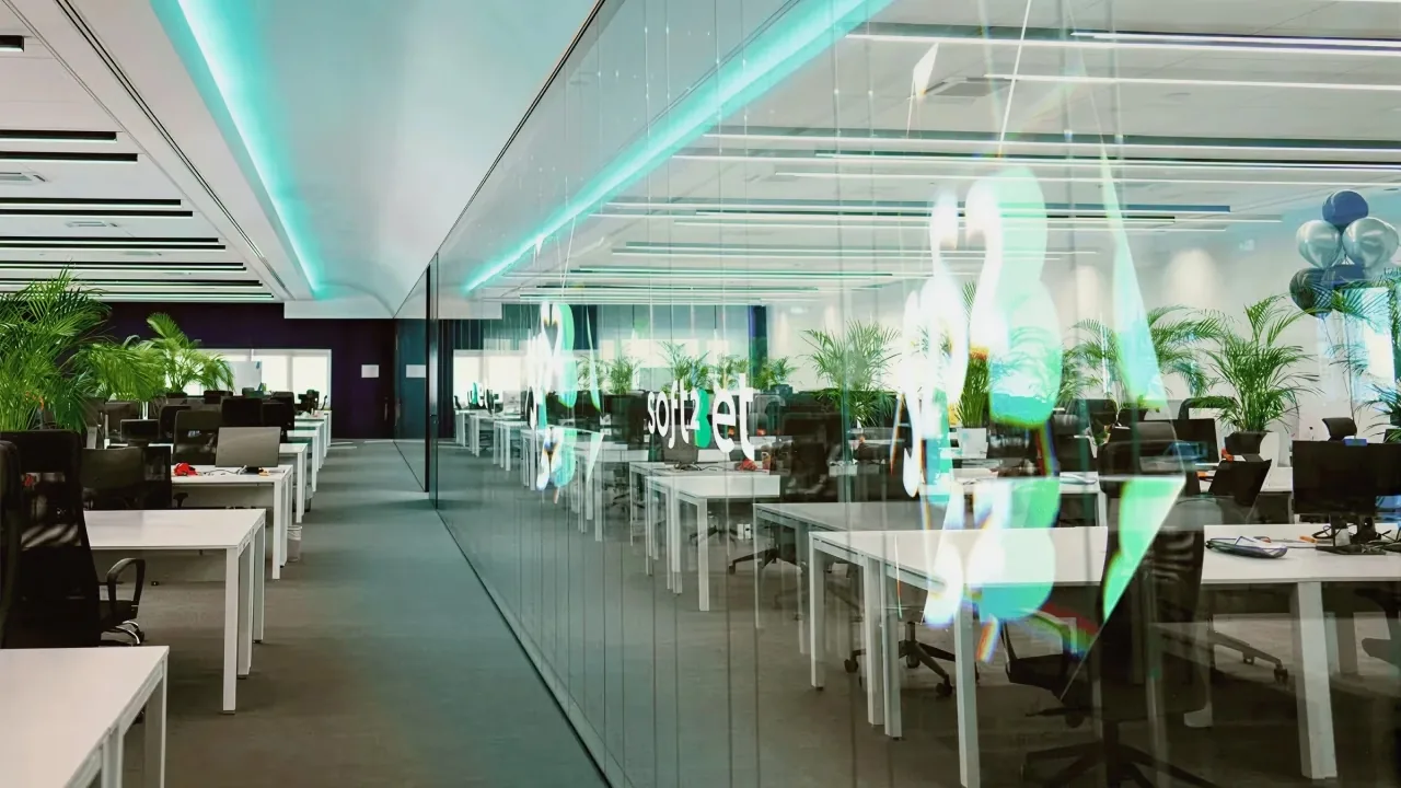 Open-plan office where Soft2Bet specialists work on player accounts